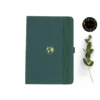 A5 dot grid notebook with a green cover and world illustration
