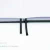 Dark grey leather-textured fabric notebook with rounded corners, matching elastic band, pen loop, and dual ribbon bookmarks, shown with a green and yellow fountain pen illustration and a floral 'joie' logo