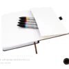 A5 dot grid notebook with a playing cat illustration on the cover