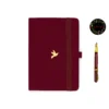 A5 dot grid notebook with a burgundy cover and a bird illustration