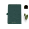 Deep green fabric-covered notebook with rounded corners, matching elastic band, pen loop, and dual ribbon bookmarks, shown with a white flower and a floral 'joie' logo