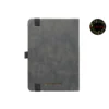 Dark grey leather-textured fabric notebook with rounded corners, matching elastic band, pen loop, and dual ribbon bookmarks, shown with a green and yellow fountain pen illustration and a floral 'joie' logo