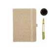 Light yellow fabric journal with rounded corners, elastic closure, pen holder, and dual bookmarks—paired with an illustrated fountain pen and floral 'joie' logo