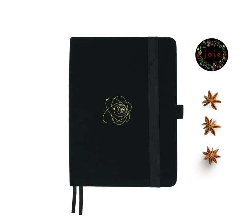 A5 dot grid notebook with a fabric cover and gold illustration of the Universe