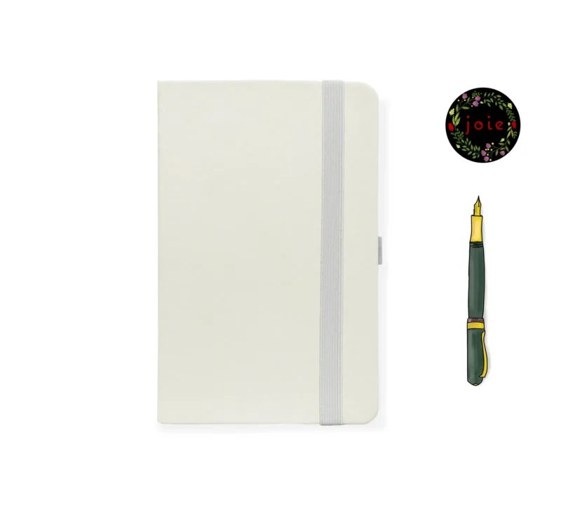 White A5 faux leather dot grid notebook with white elastic band, pen loop, Joie floral logo, and illustrated fountain pen
